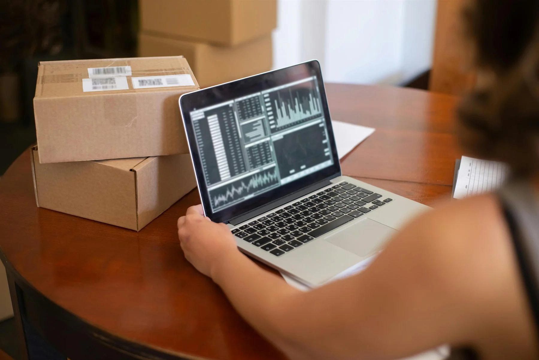 Workspace with marketing reports and shipping boxes