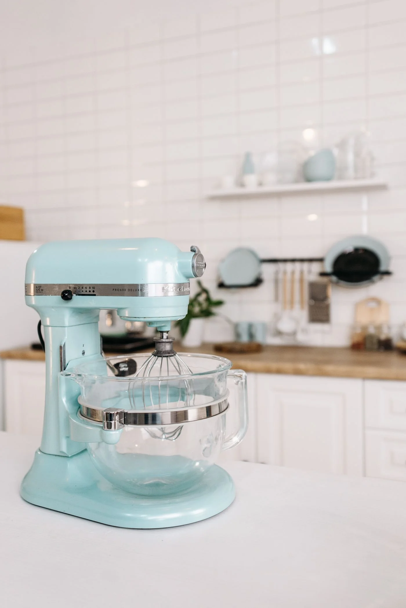 Mint green stand mixer in a bright kitchen